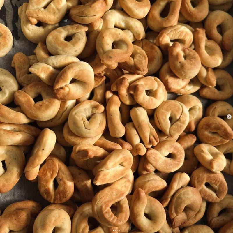 Photo of taralli spread out on a baking tray